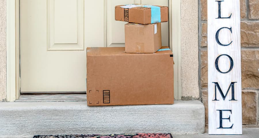 Packages on the doorstep of a home with a welcome sign in Hartford